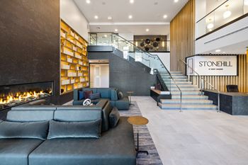 the lobby of stonewall hotel with couches and a fireplace at Stonehill at West Orange, West Orange